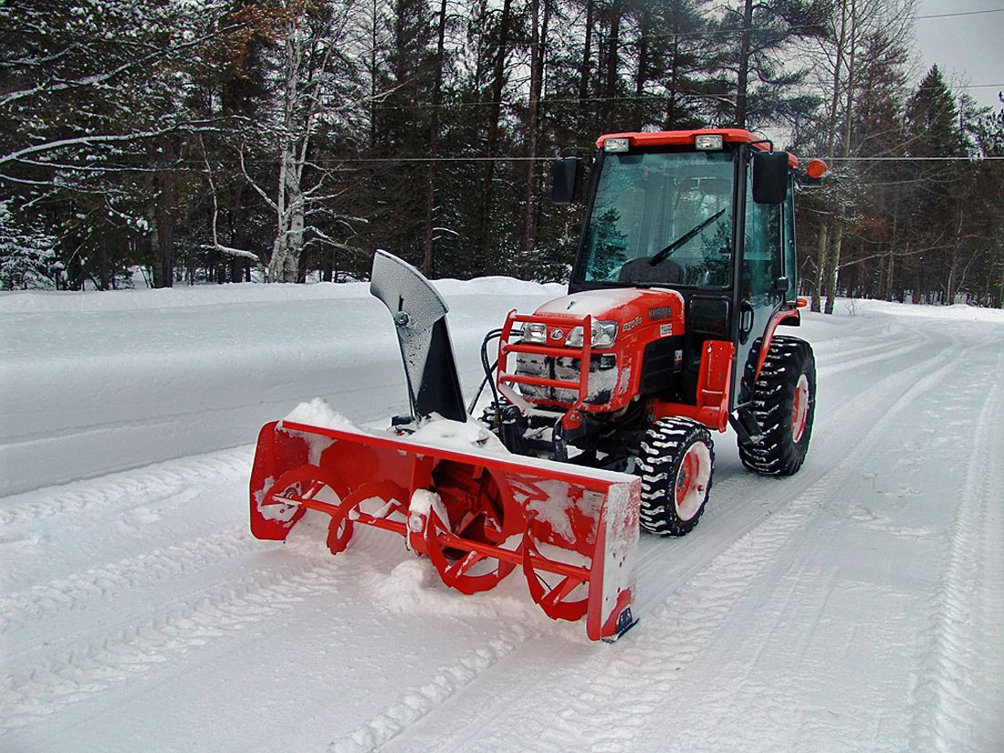 red tractor removing snow